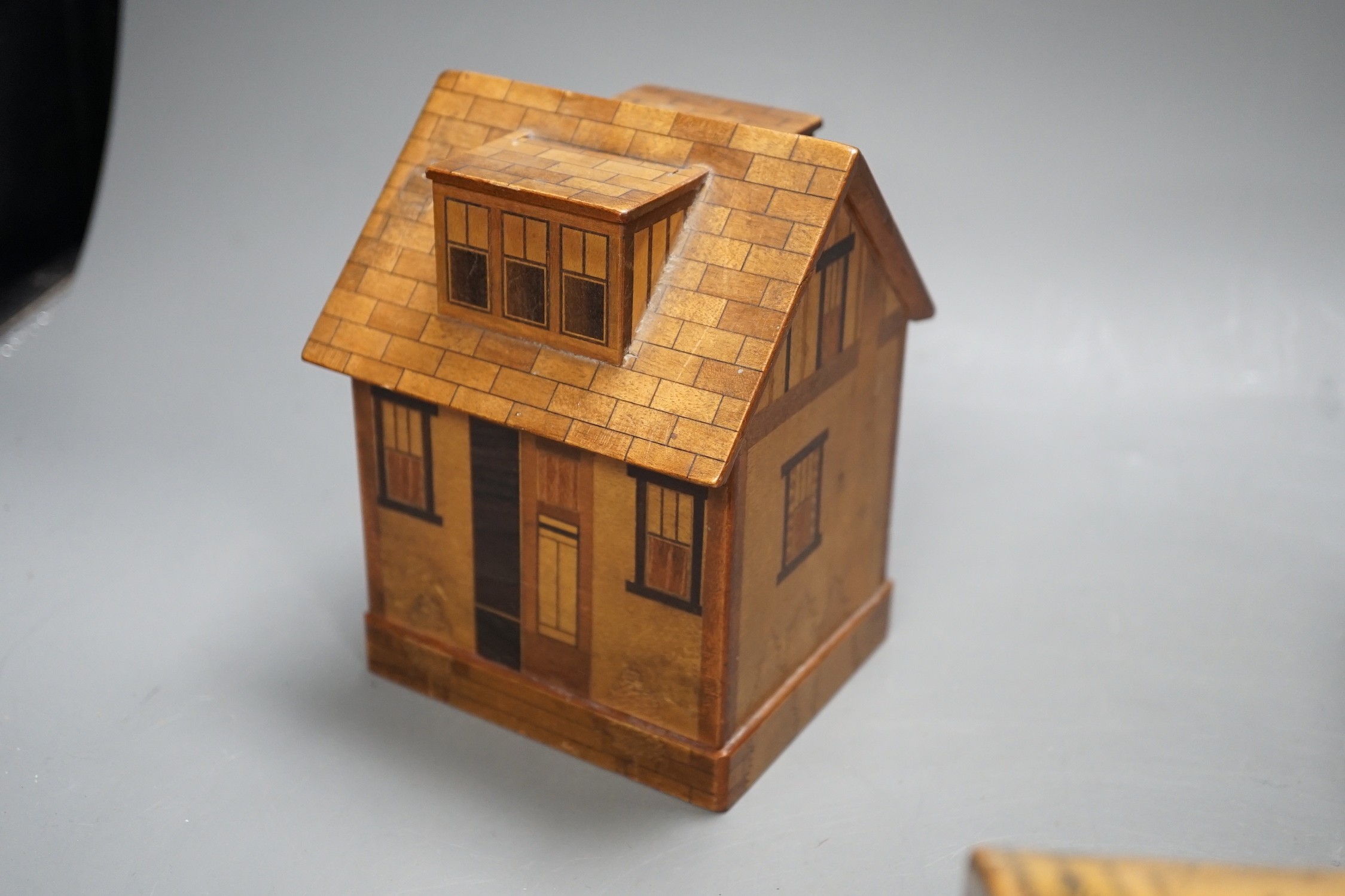 A selection of treen boxes, to include a house shaped money box, 13cm high, a 19th century ash? dome top tea caddy, with ivory finial to the cover (5)
